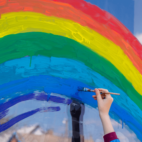 Child painting rainbow