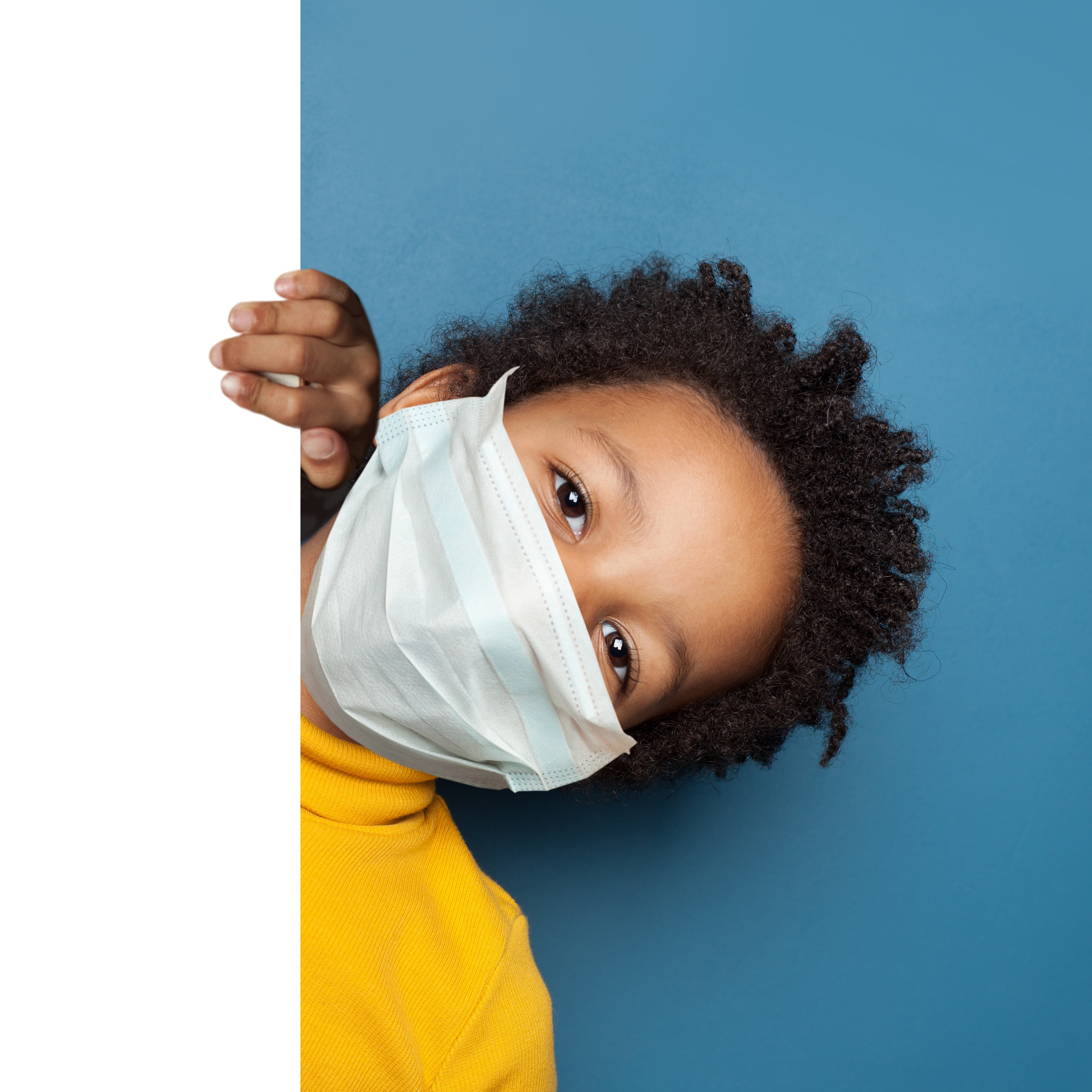 Child staying safe from Covid with a face mask