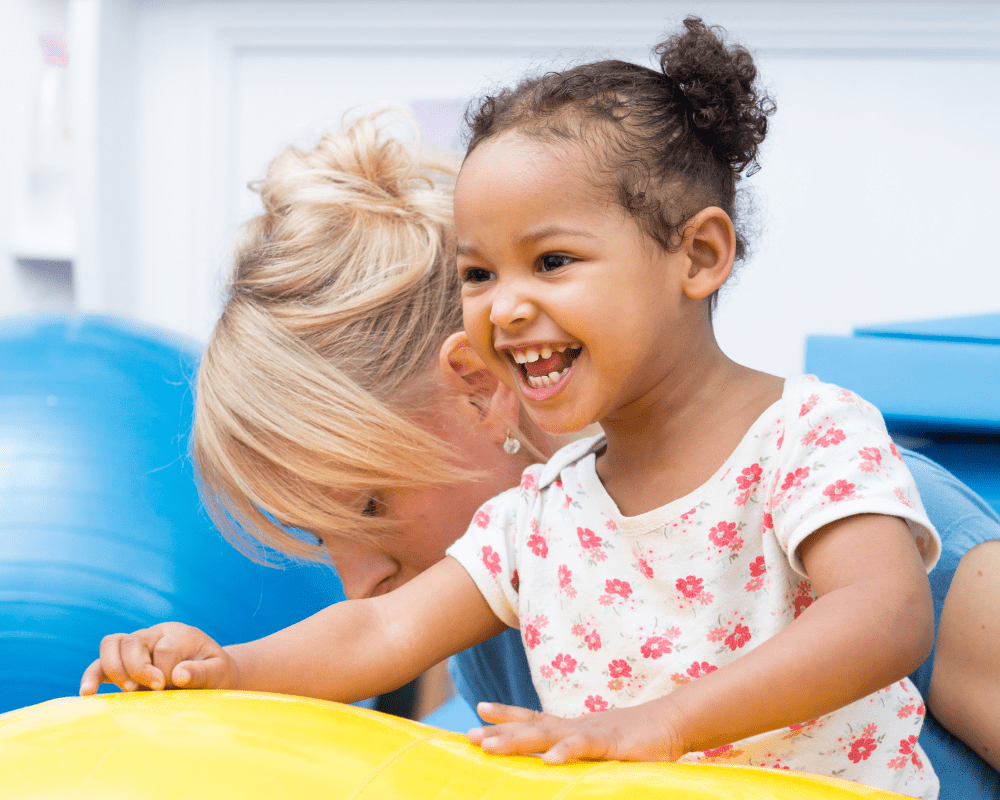 Smiley little girl with physiotherapist at the CPPC Centre