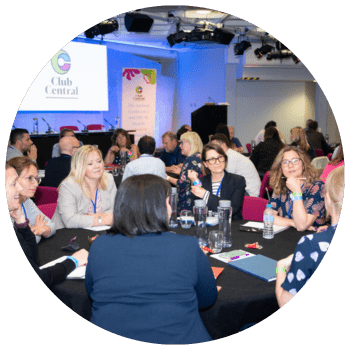 Group of people sitting around a table talking and networking at The Club Central Conference and Out of School Club Awards (OSCAs) 2022