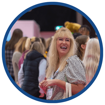 Focus on lady smiling in crowd of people at Childcare and Education Expo event 