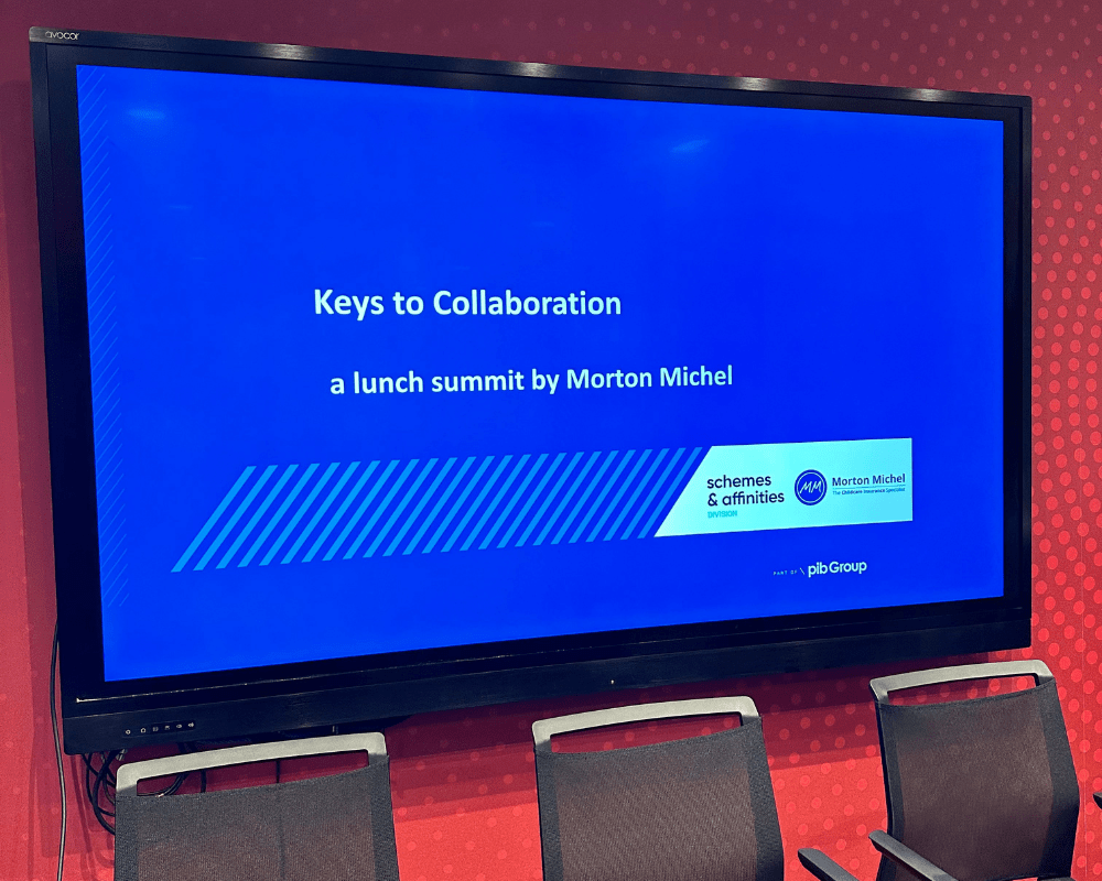 Television screen showing presentation slide of Morton Michel's Keys to Collaboration lunch summit