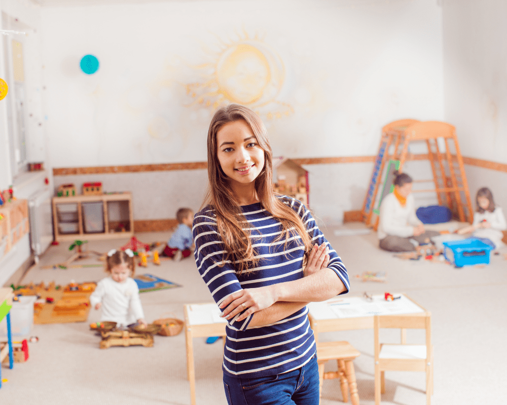 Young female teacher in nursery school room