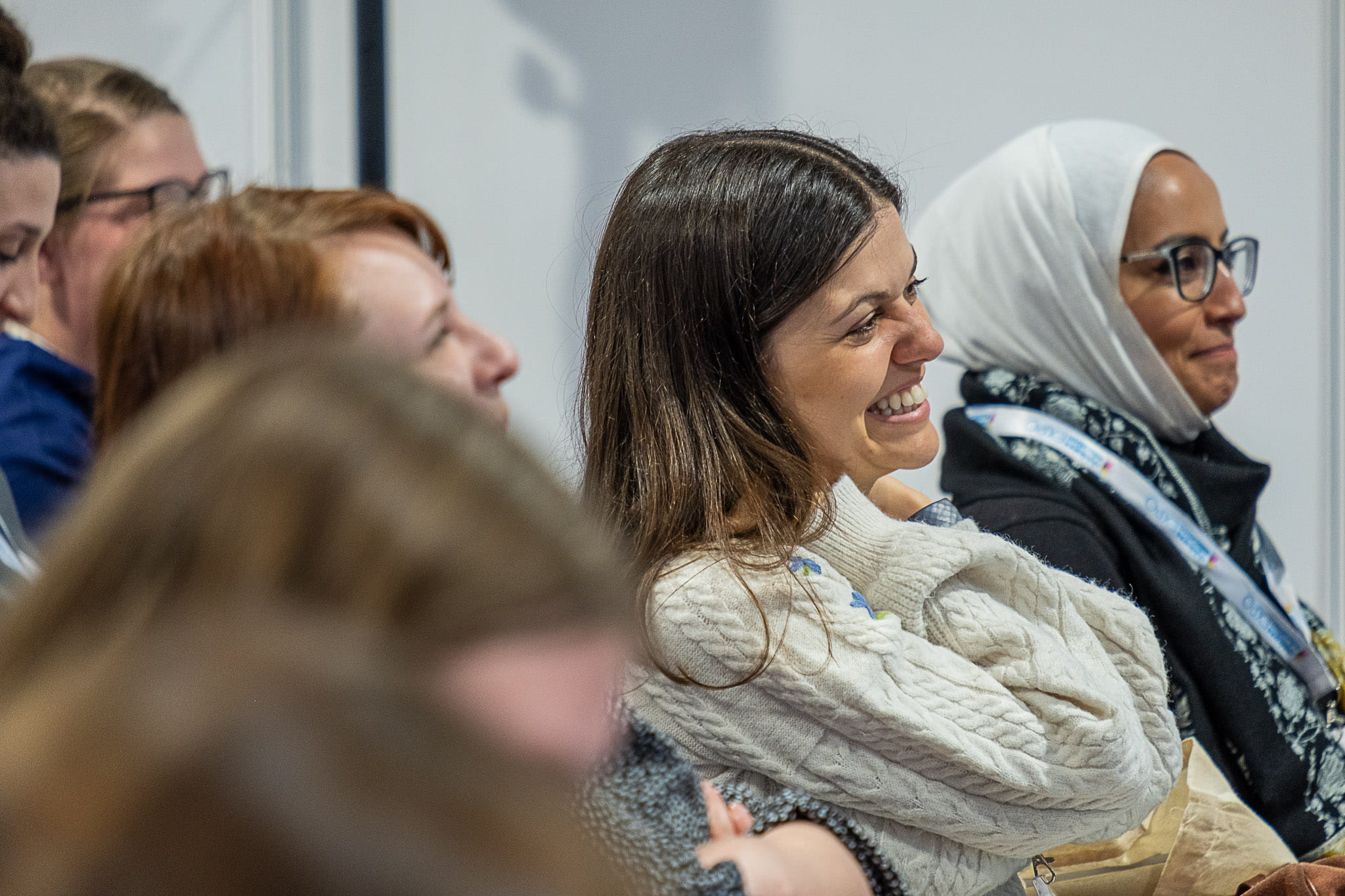 Lady smiling while attending a seminar at a Childcare and Education expo event