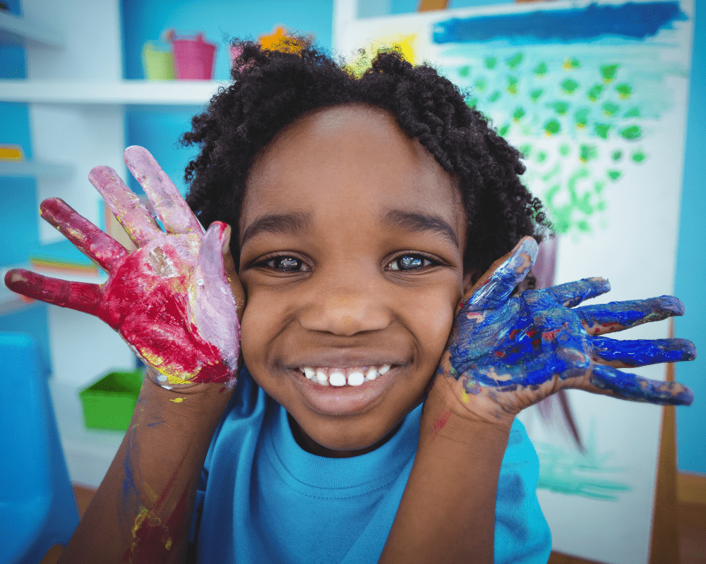 Happy kid enjoying arts and crafts painting