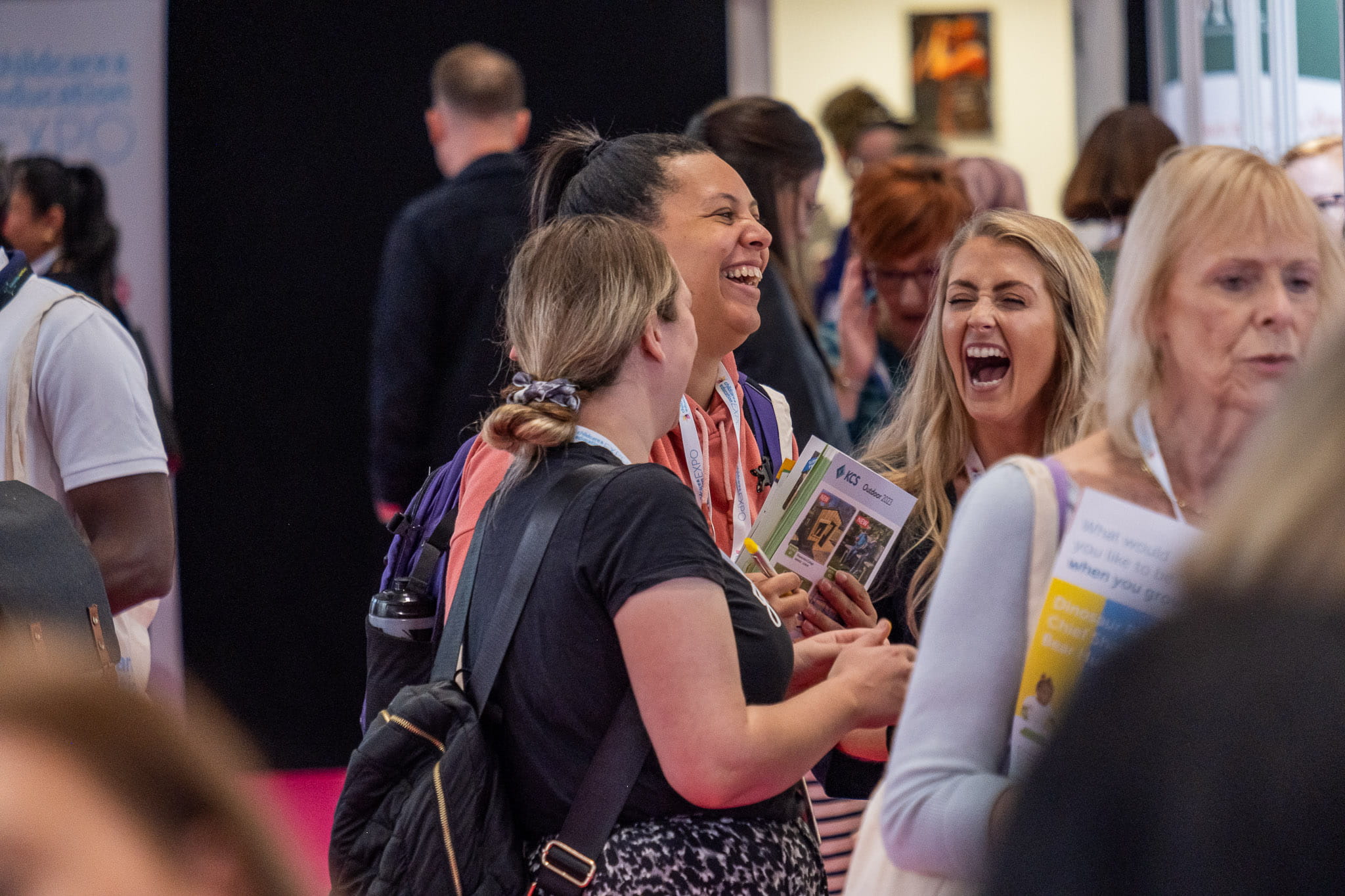 Group of 3 attendees at one of the Childcare and Education Expo events, laughing together