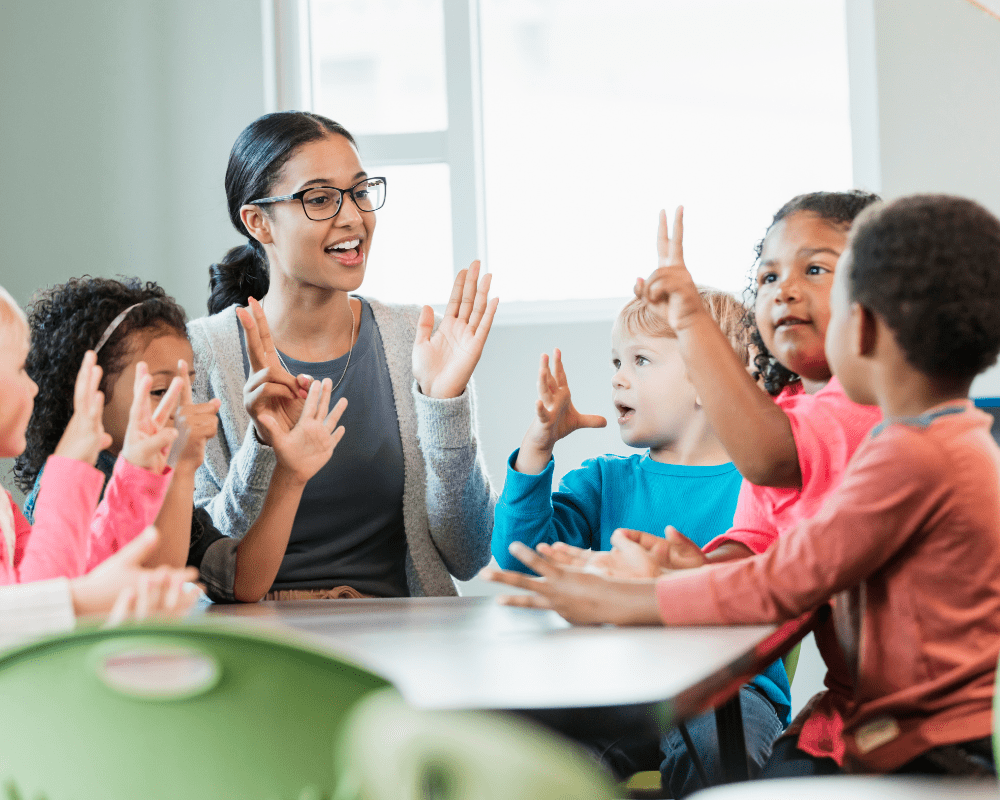 Preschool teacher and students learning together in classroom