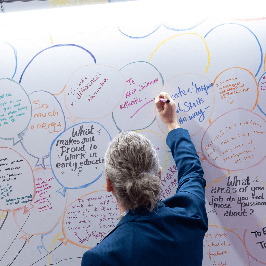 Alistair Bryce-Clegg writing on the 'What's My Why?' wall at the Childcare & Education Expo London 2024