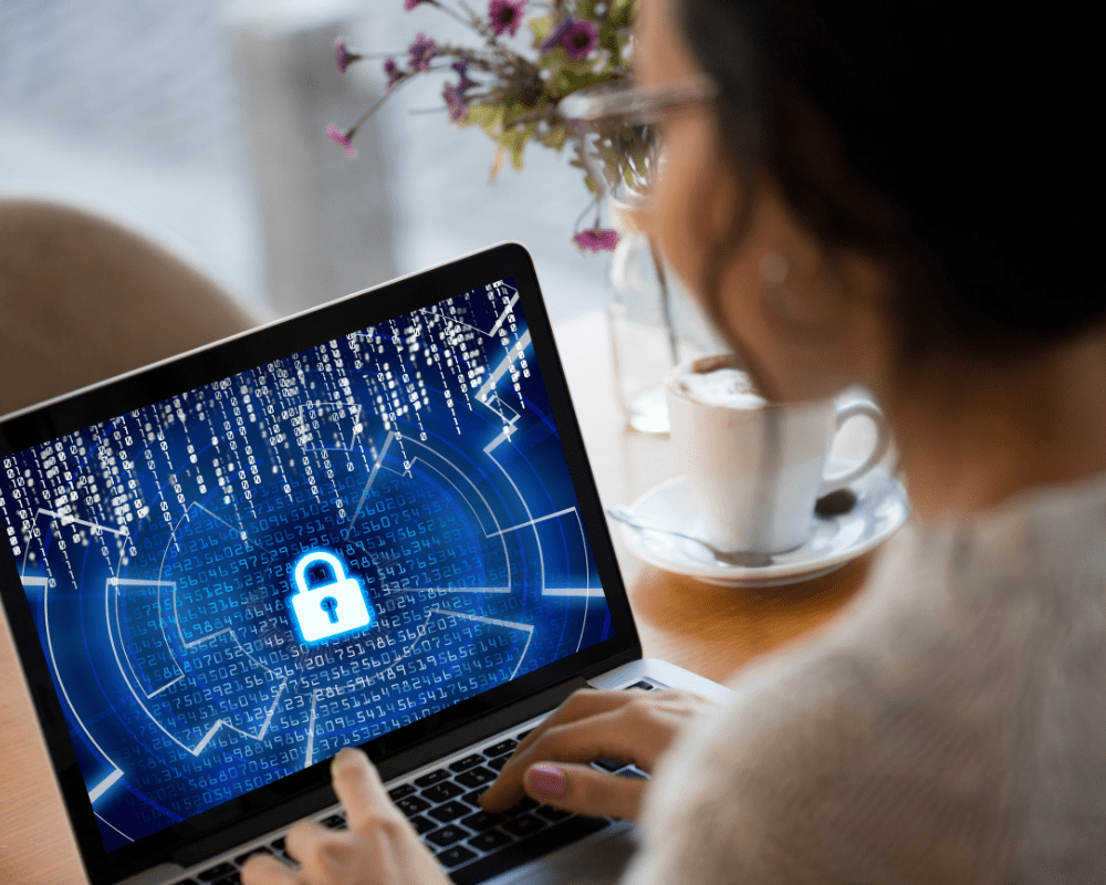 Side profile of woman using laptop with cyber security concept.