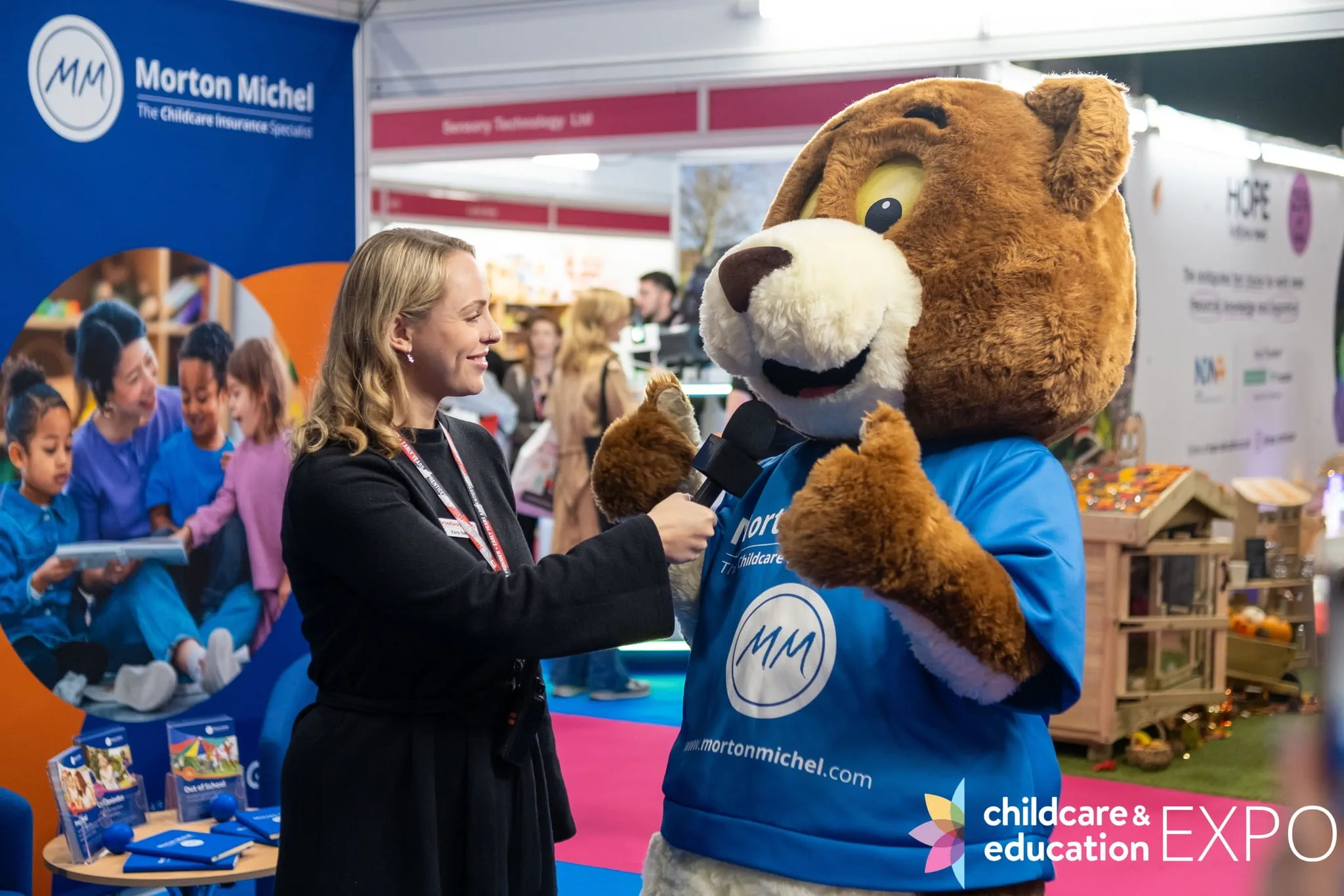 Mascot bear being interviewed at Childcare & Education Expo London 2025