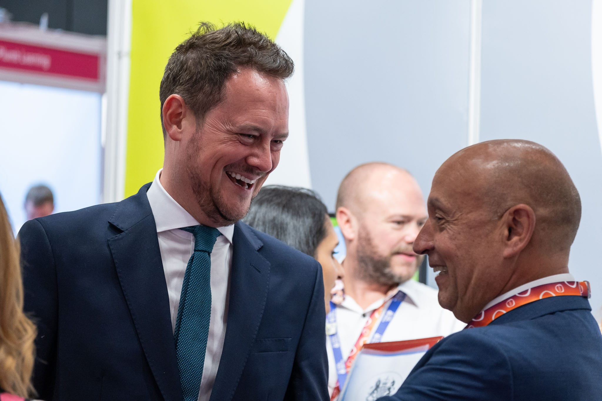 Stephen Morgan, Labour MP for Portsmouth South, laughs with a guest at an exhibition