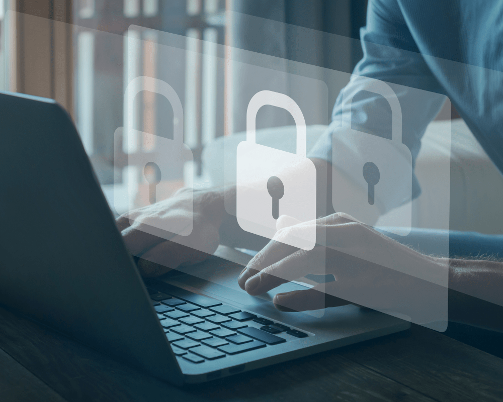 Cyber security concept - close up of man typing on laptop with white padlocks icons hovering over