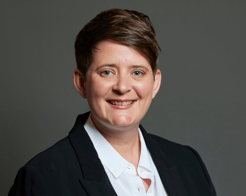 Early Years Minister, Olivia Bailey, looking directly at camera and smiling.