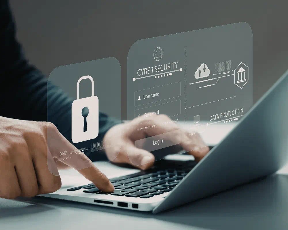 A person is typing on a laptop with a focus on cybersecurity elements such as a lock icon and security-related text