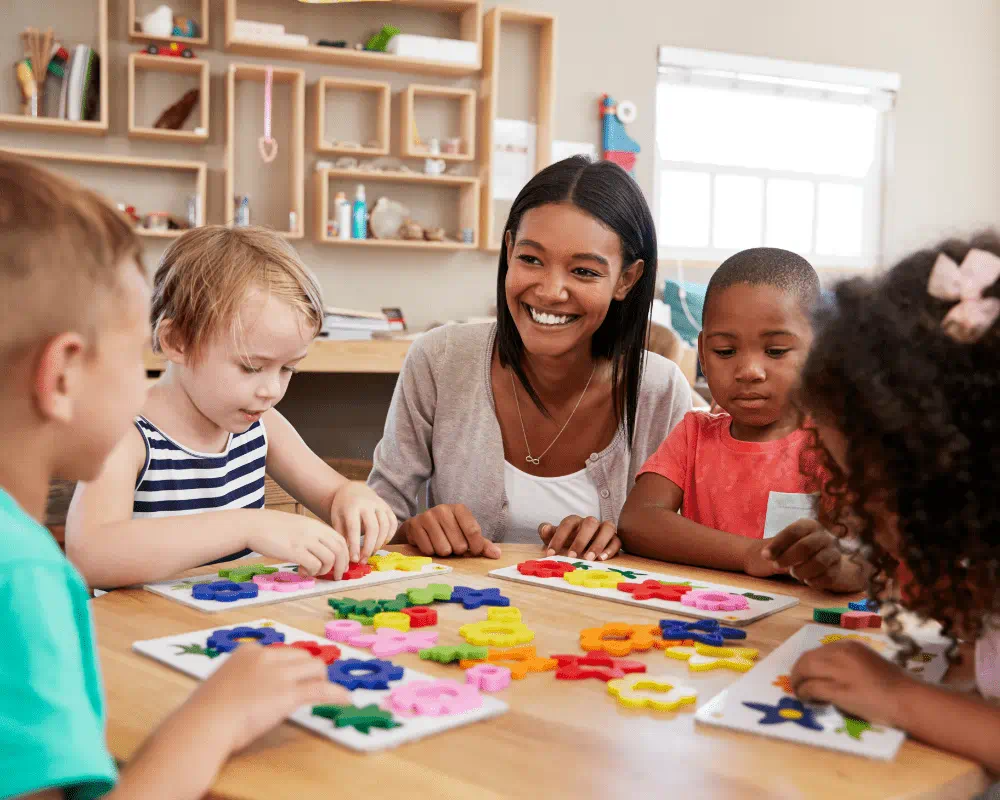 Teacher and young children using flower shapes in Montessori classroom
