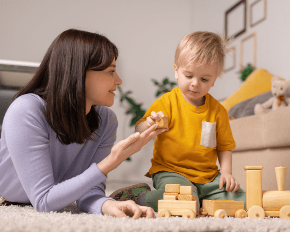 Brunette childminder helping young boy 