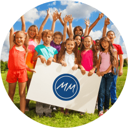 A photograph of a group of children holding a Morton Michel sign.