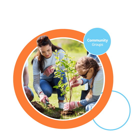 A photograph of a child and carer planting in a community care setting.