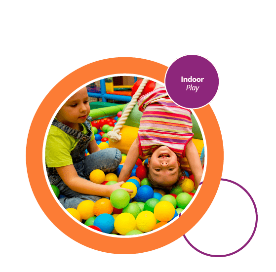 2 young children playing in a ball pool.