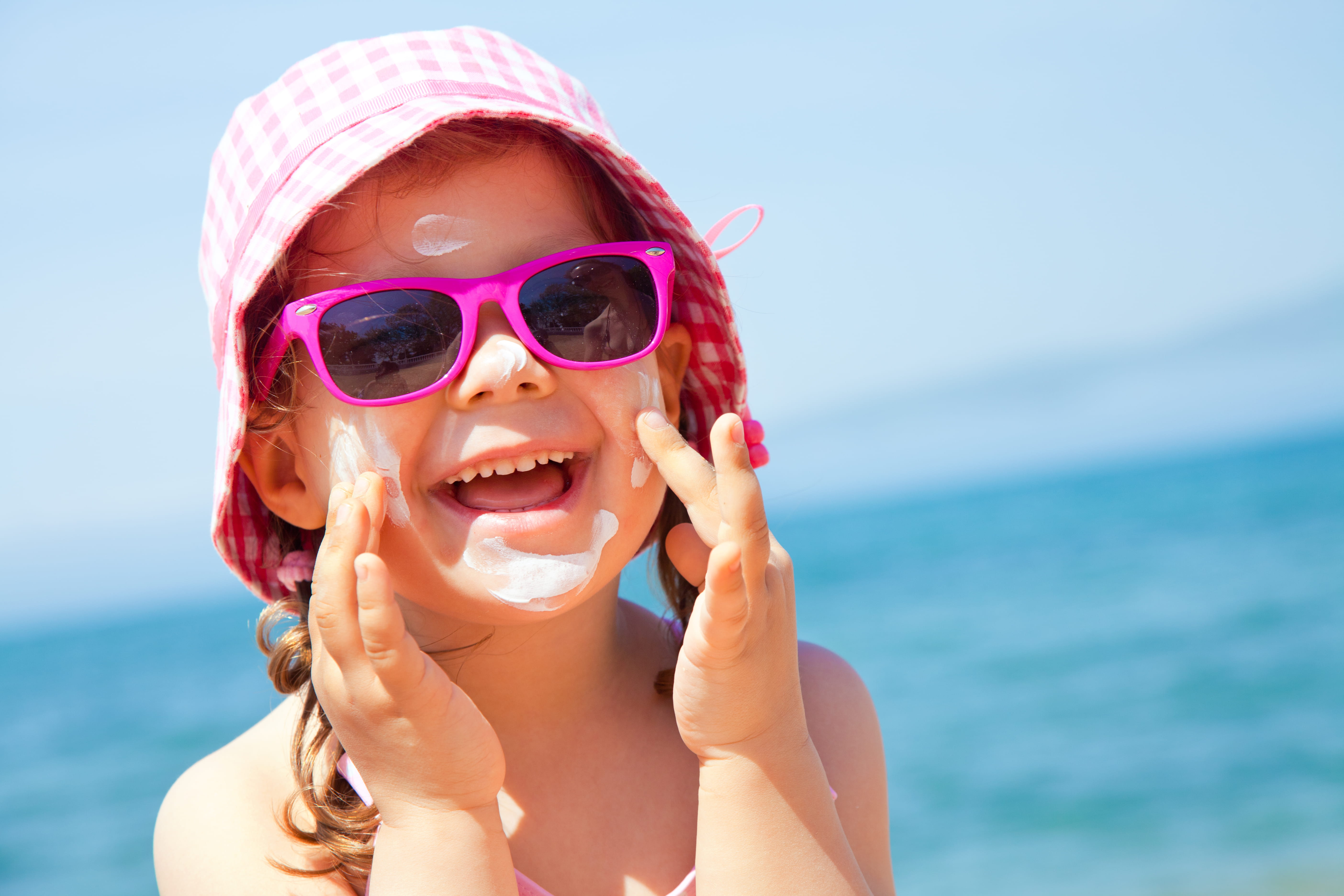 Girl putting on sun cream
