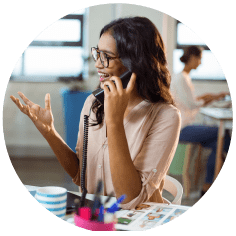 Roundel image showing happy woman on the phone at work
