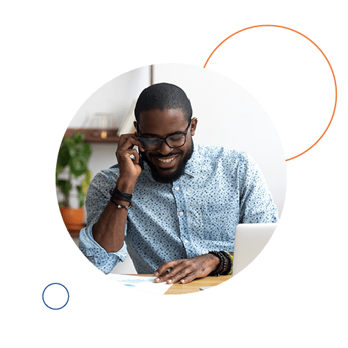 A man on the phone, smiling.