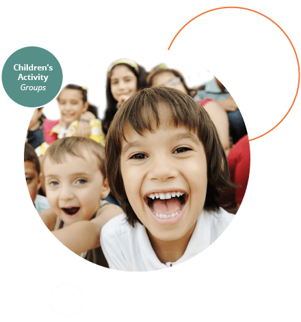 A group of children laughing and smiling into the camera.