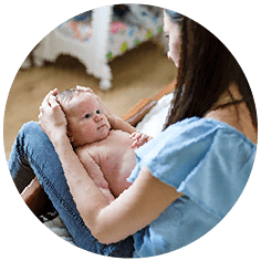 Maternity nurse holding baby on lap