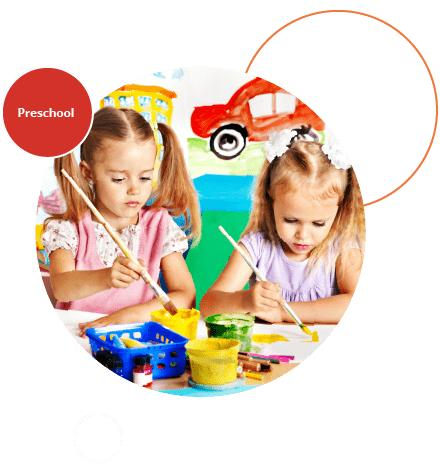 2 young girls painting together at a table.