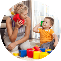 A photograph of a child and carer playing with toy telephones.