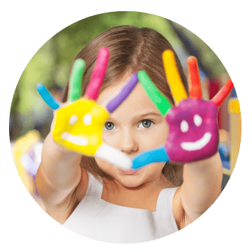 Young girl showing the palms of her hands to the camera which are painted with bright colours and smiley faces