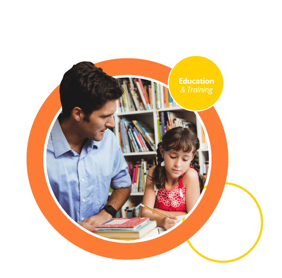 A child and an adult in a library, learning from a book.