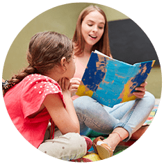 Childminder reading book to child